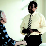 Doctor checking blood pressure of senior man --- Image by © Laura Doss/Corbis